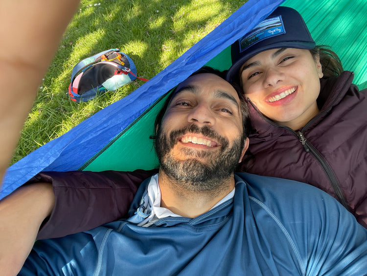 Alex & Cristina post for picture in their tent while camping.